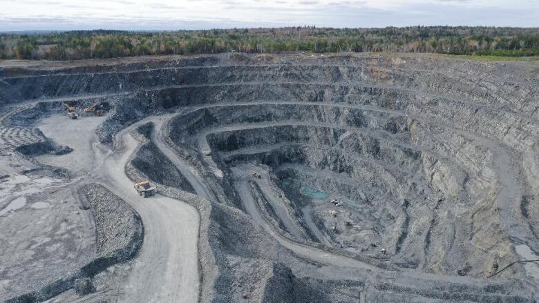 An aerial shot of an open-pit gold mine.