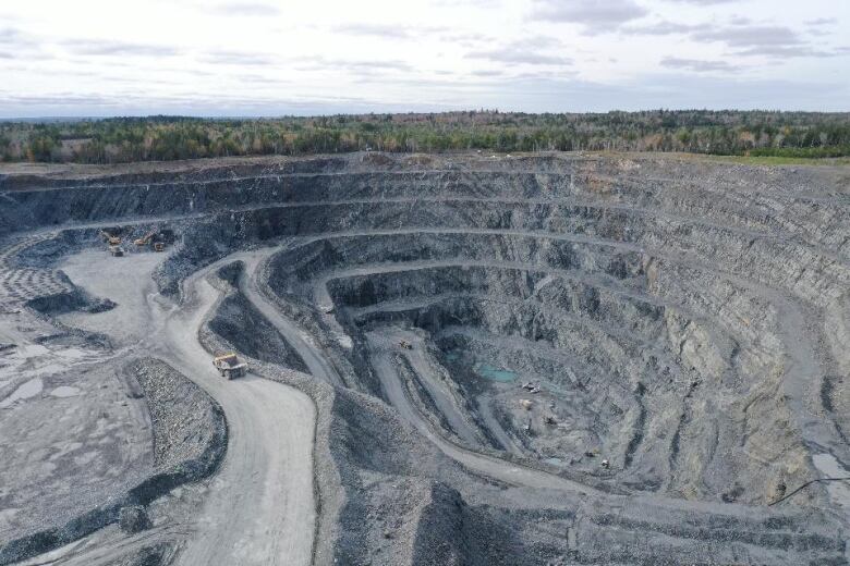 An aerial shot of an open-pit gold mine.