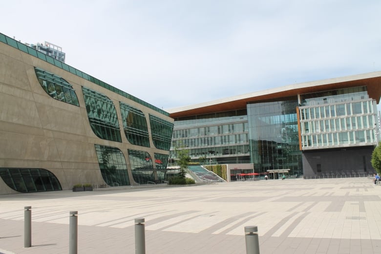 Two large horizontal buildings largely composed of glass.