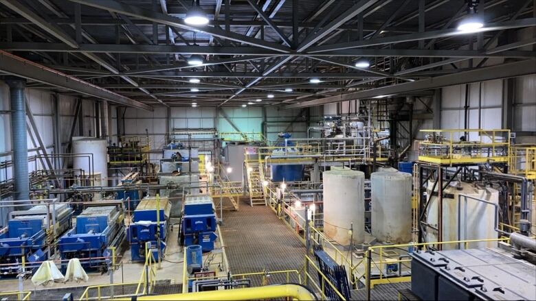 Industrial equipment is seen on the inside of a refining plant.