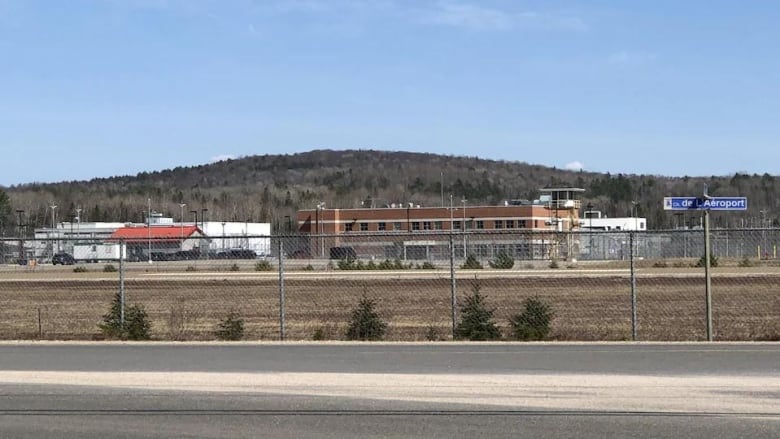 A building surrounded by a chain link fence.