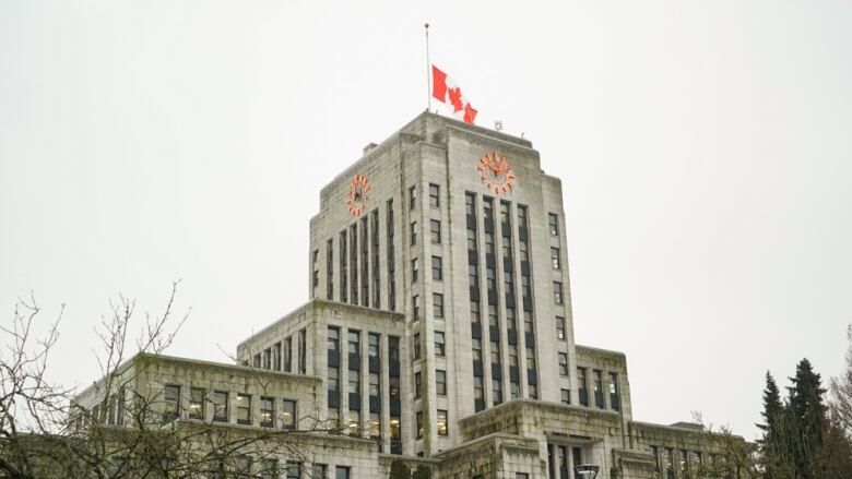 Vancouver City Hall with a flag lowered at half-mast.