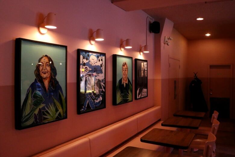 Prints hanging on the wall of a movie theatre