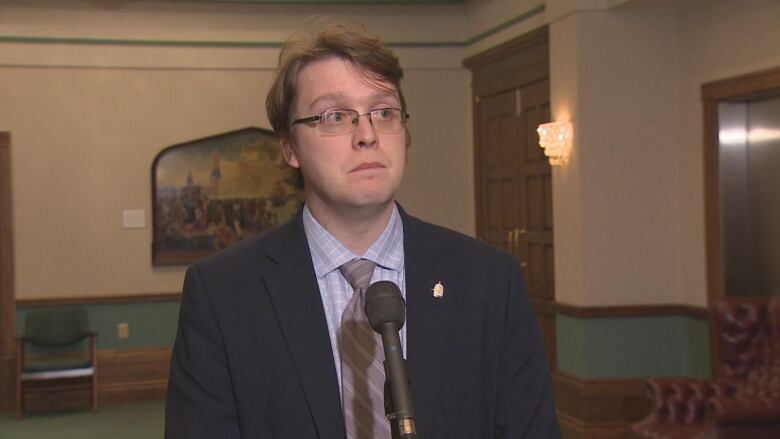 A close up photo of MHA Jordan Brown standing outside the House of Assembly. 