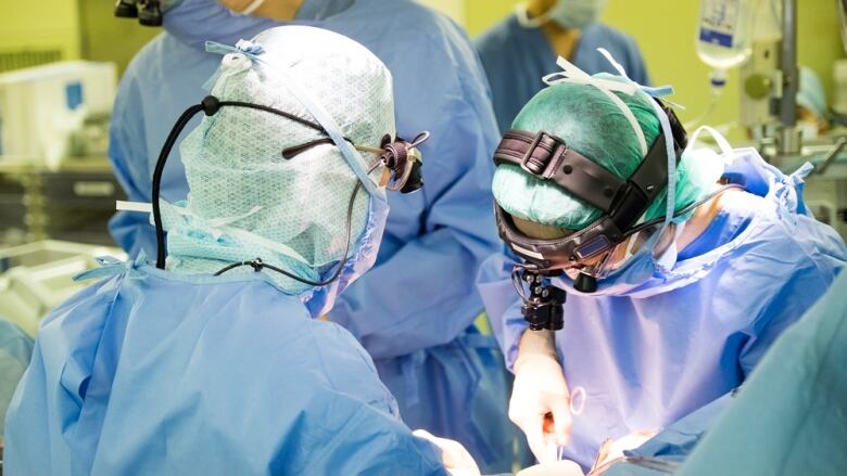 Doctors perform a surgery in an operating room.