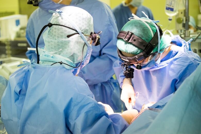 Doctors perform a surgery in an operating room.