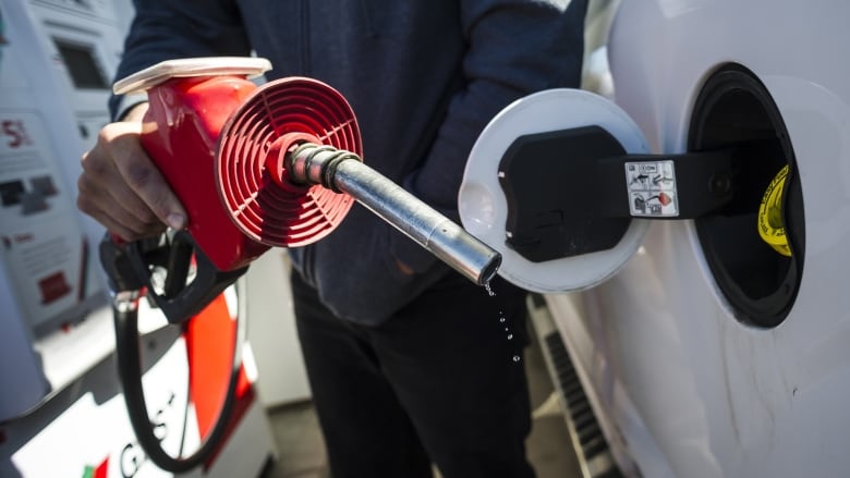 A man fills up his truck with gas in Toronto, on Monday April 1, 2019