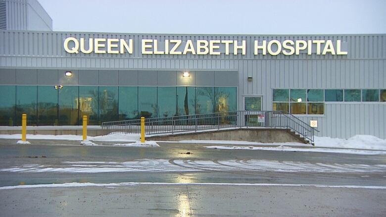 A grey industrial building  with the words, Queen Elizabeth Hospital, in white text.