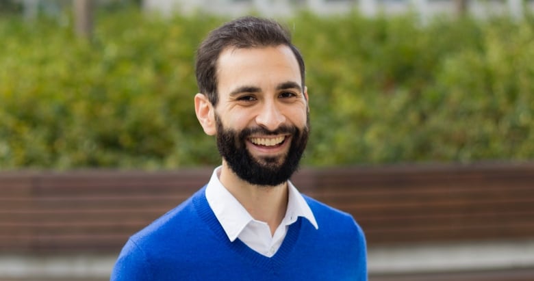 A man in a blue sweater