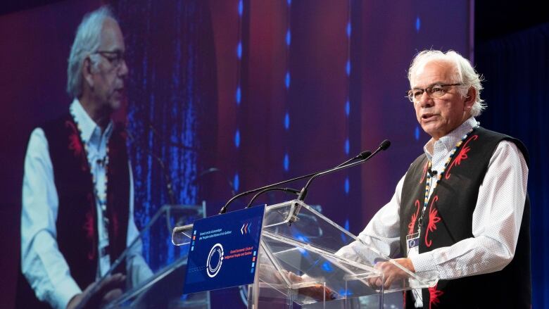 Ghislain Picard standing behind a podium