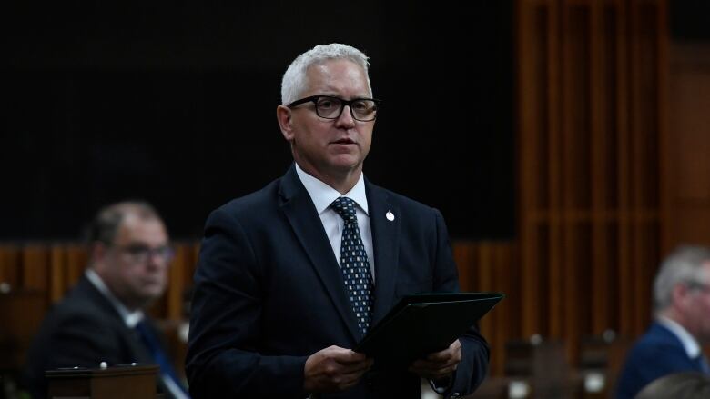 Conservative MP Gary Vidal, wearing a dark suit, glasses and a tie, stands in the House of Commons.