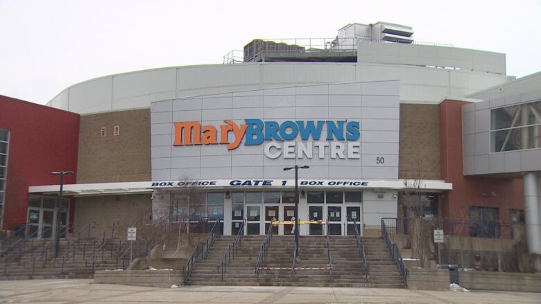 The front doors of a stadium are pictured in a wide photo.