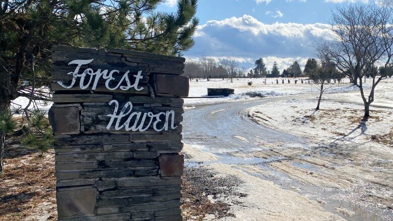 A stone marker is at the entrance to Forest Haven funeral home.