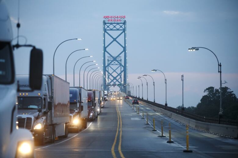 Commercial trucks and passenger vehicles drive across Ambassador Bridge on the Canada-U.S. border in Windsor, Ontario, Canada, on Thursday, Aug. 9, 2018. The Ambassador Bridge connects Canada to USA, from Windsor to Detroit and facilitates over 30% of all Canada-US road trade. Photographer: Cole Burston/Bloomberg