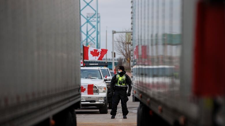 Police officer standing in the middle of the Ambassador Bridge blockade.