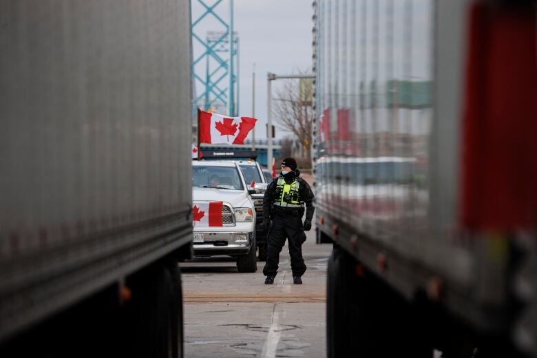 Police officer standing in the middle of the Ambassador Bridge blockade.