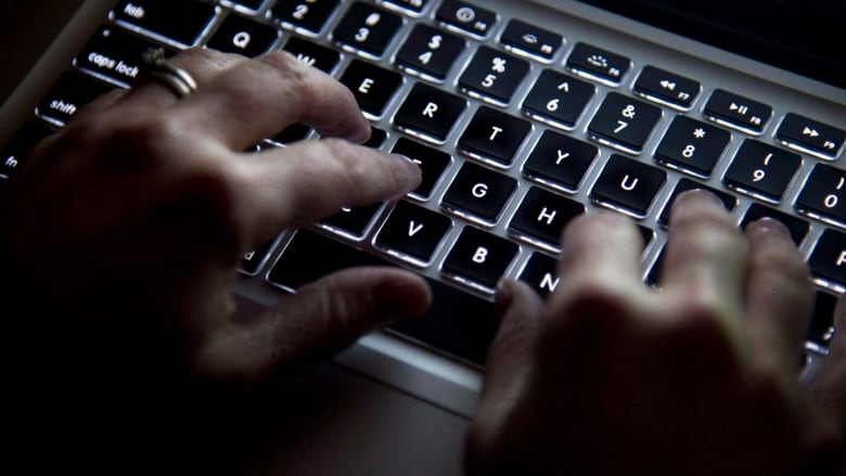 File photo fingers on computer keyboard.