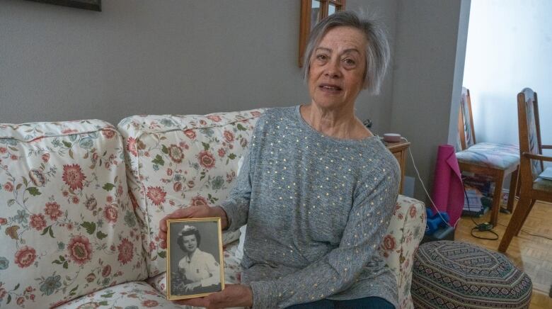 Kathryn Fournier holds a photo of her mother Edith, who joined her as a plaintiff in the case against the federal government.