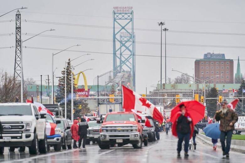 Anti-vaccine mandate protestors block the roadway at the Ambassador Bridge border crossing, in Windsor, Ontario, Canada on February 11, 2022. - The protestors who are in support of the Truckers Freedom Convoy in Ottawa have blocked traffic in the Canada bound lanes from the bridge since February 7, 2022. Approximately $323 million worth of goods cross the Windsor-Detroit border each day at the Ambassador Bridge making it North Americas busiest international border crossing. (Photo by Geoff Robins / AFP) (Photo by GEOFF ROBINS/AFP via Getty Images)