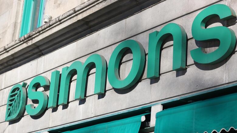 The logo for Canadian retailer Simons is affixed to a building.