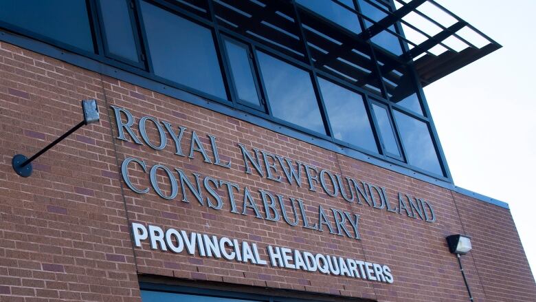 A red brick building with the words Royal Newfoundland Constabulary, provincial headquarters on a sign. 