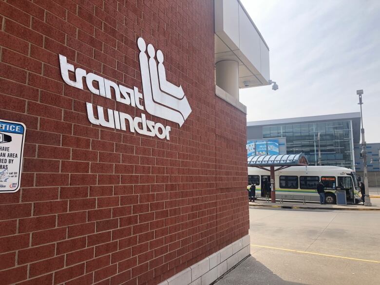 A sign read Transit Windsor with a bus in the back. 