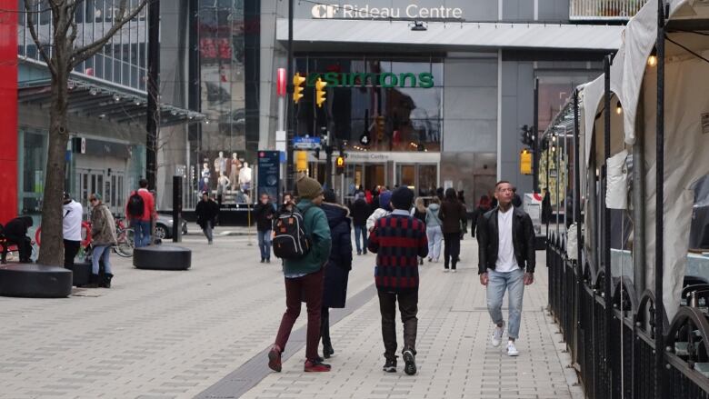 People walk outside a mall.