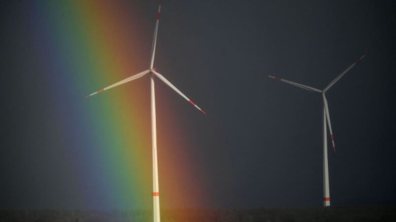 A rainbow is seen behind wind turbines near Breuna, western Germany on February 17, 2022.