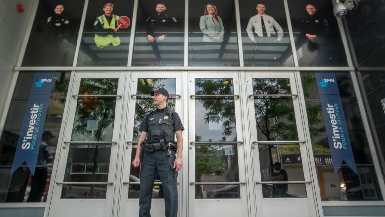 A police officer in front of a building.