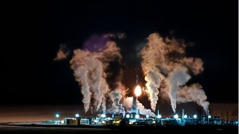 Night shot of a gas plant in northeastern B.C., where there are big clouds coming from the operation.