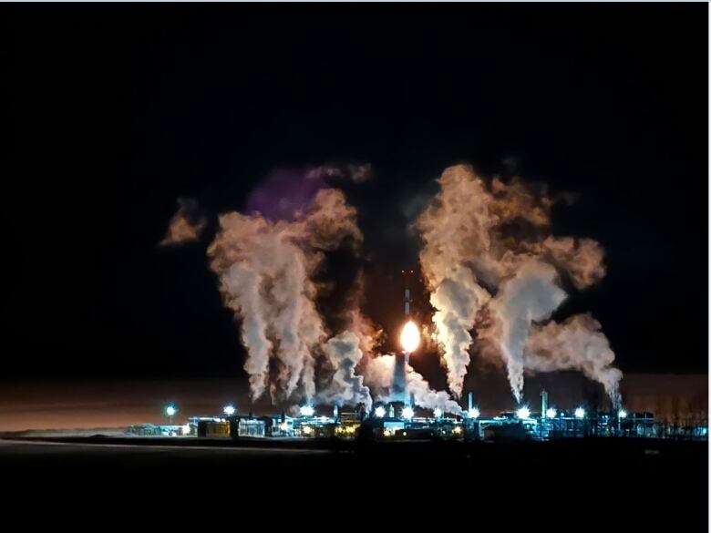 Night shot of a gas plant in northeastern B.C., where there are big clouds coming from the operation.