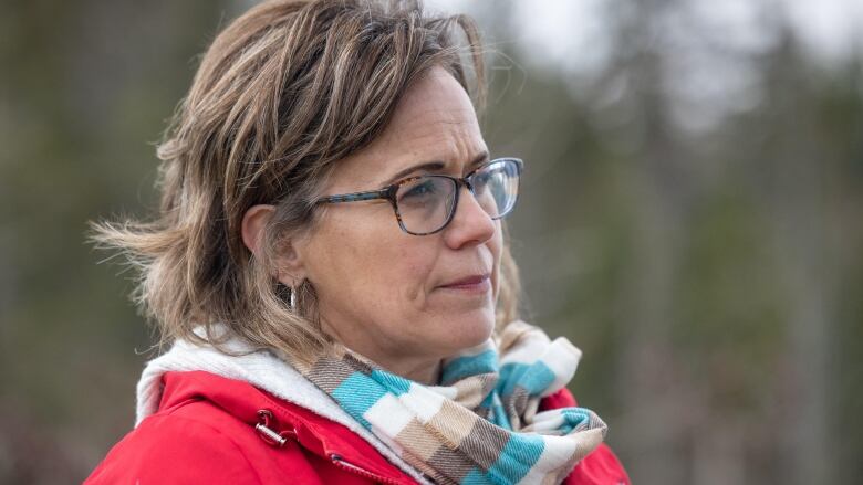 A woman in a scarf and a red jacket