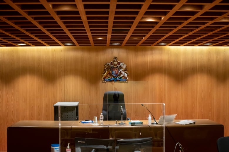 A desk with a crest over it.