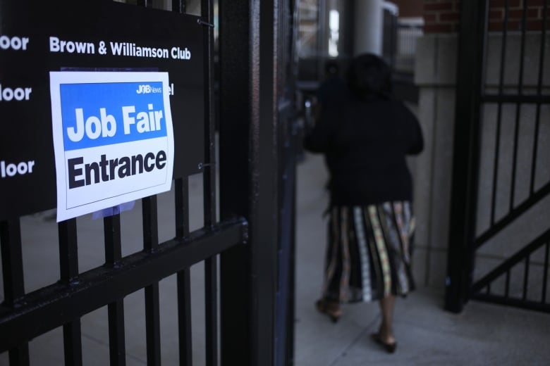 A sign advertising a job fair is shown on a window