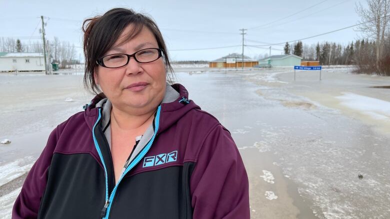 A portrait of a woman on a flooded street.