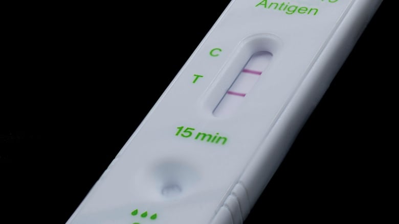 A rapid COVID-19 test displays a positive result.