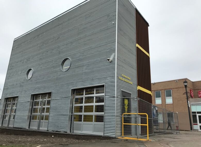 A structure made of shipping containers is shown in this photo.