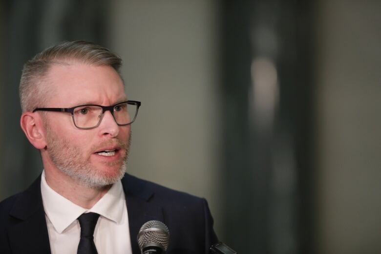 The minister responsible for mental health and addictions care, Everett Hindley, speaks with reporters at the Saskatchewan legislative building on May 17, 2022. 