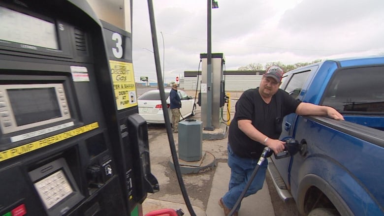 A man at a gas pump