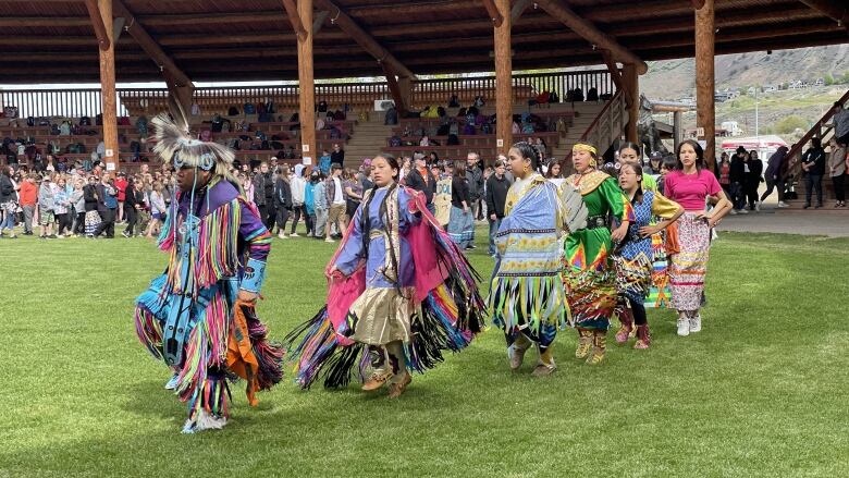 Powwow dancers perform at campground.