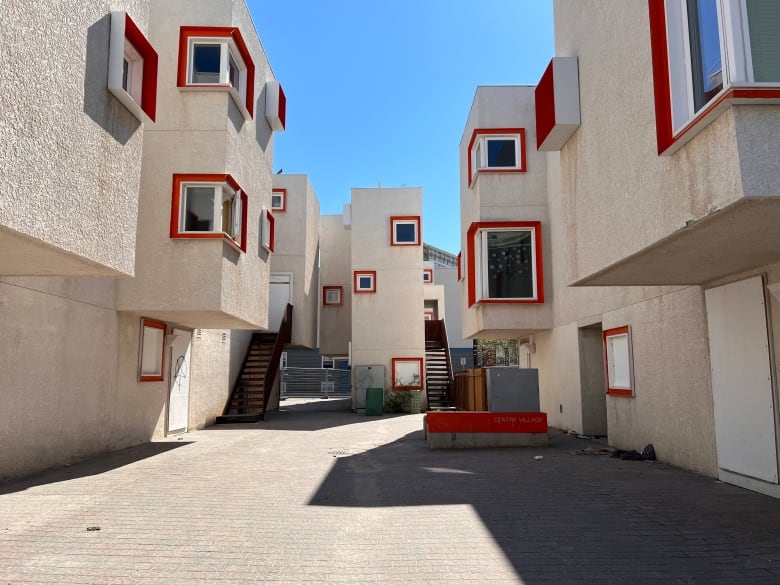 Beige modular buildings with orange frames around windows.