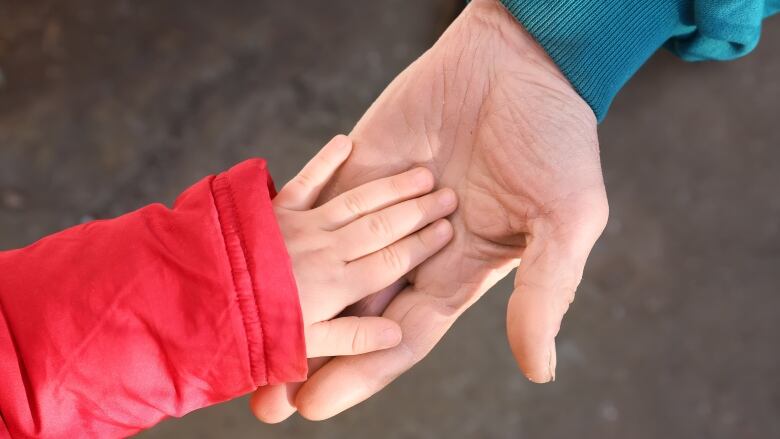 An elderly man opened his palm to a small children's hand.