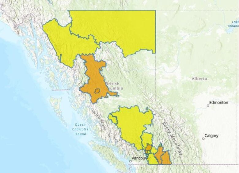 A map of British Columbia, with some areas highlighted orange or yellow depending on whether they are under high streamflow advisory or flood watch. Two regions in northern B.C. are on flood watch, and parts of the rest of the region are under an advisory. Much of southern B.C. is on an advisory, with four regions near the U.S. border on flood watch.