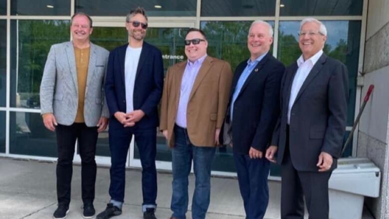 Five men, including North Star Studios President Mitch Ouimette, at a press conference for the company.