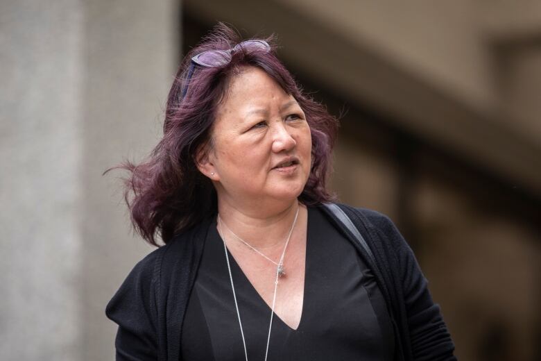 Carol Todd looks away from the camera. She is wearing a black top and has purple-tinted hair.