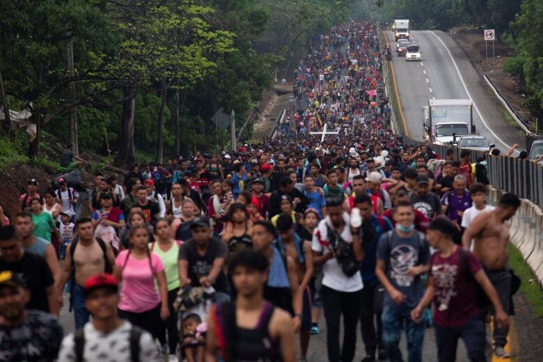 Huge crowd of people, tens of thousands, walking together