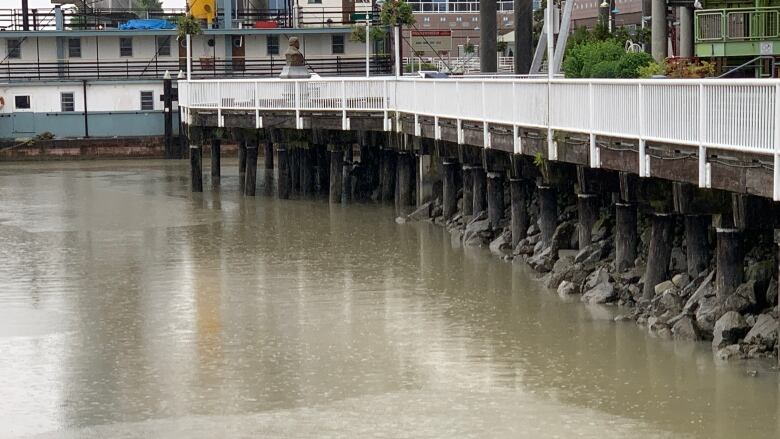 Rain falls on the swollen Fraser River at the New Westminster Quay on June 9, 2022.