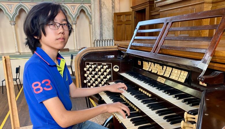 Teenager playing pipe organ