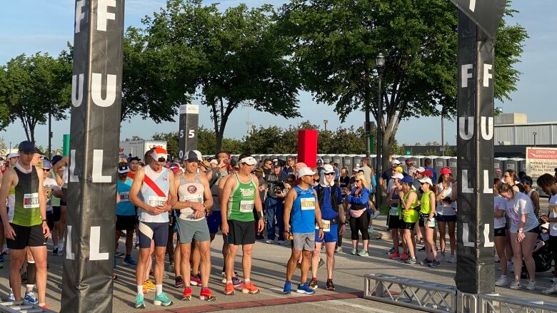 People line up to run the start of a marathon