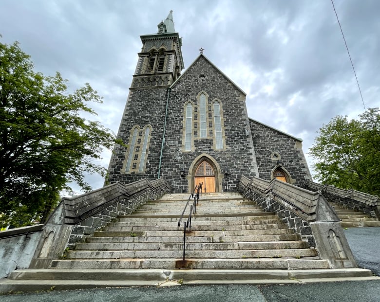 A stone church, with its steep steps in the foreground. 